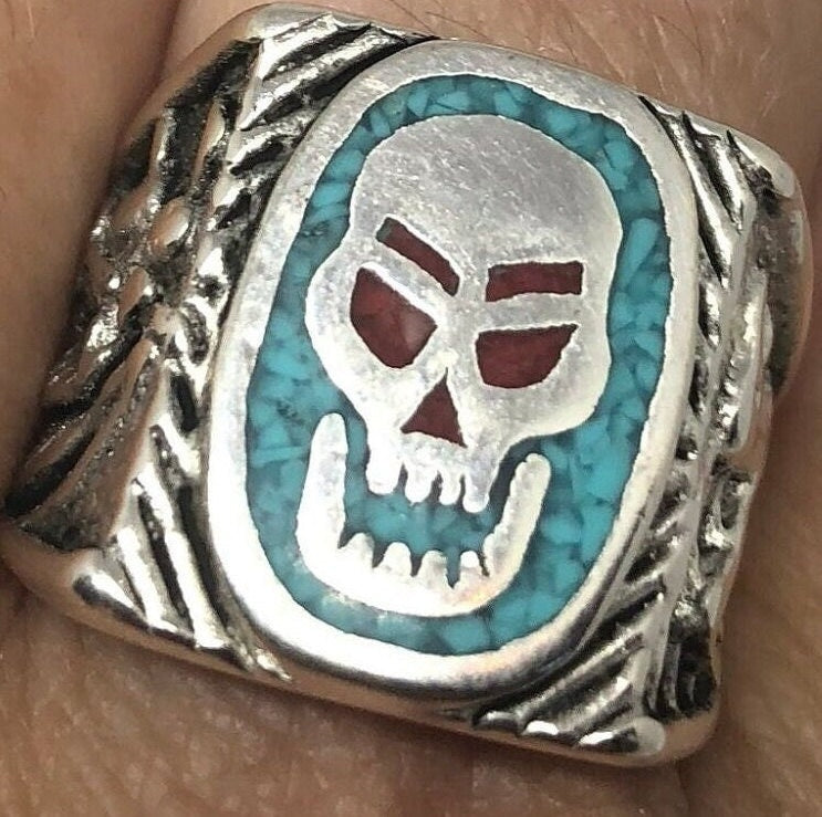 Skull ring with blue turquoise and red coral in white bronze on finger